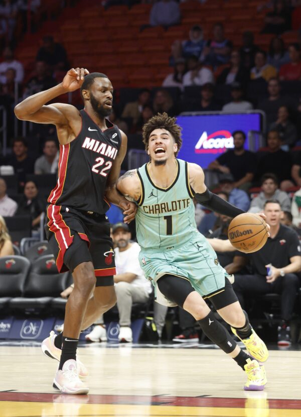 Miami Heat forward Andrew Wiggins (22) defends Charlotte Hornets guard LaMelo Ball (1) during the first half at Kaseya Center.