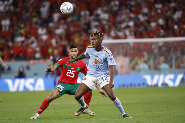 Dec 6, 2022; Ar Rayyan, QATAR; Spain forward Nico Williams (12) controls the ball against Morocco defender Yahia Attiyat Allah (25) during the second half in the round of sixteen match of the 2022 FIFA World Cup at Education City Stadium.