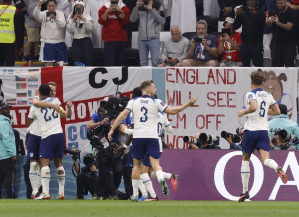 Dec 10, 2022; Al Khor, Qatar; England forward Harry Kane (9) celebrates with midfielder Jude Bellingham (22) after scoring on a penalty shot during the second half of a quarterfinal game against France in the 2022 FIFA World Cup at Al-Bayt Stadium.