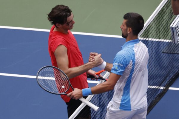 Novak Djokovic of Serbia (R) shakes hands with Taylor Fritz of the United States (L) after their match on day nine of the 2023 U.S. Open tennis tournament at USTA Billie Jean King National Tennis Center.