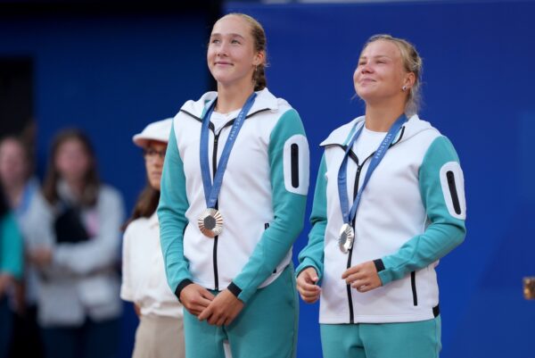 Aug 4, 2024; Paris, France; Mirra Andreeva (AIN) and Diana Shnaider (AIN) celebrate after receiving the silver medal for women’s doubles during the Paris 2024 Olympic Summer Games at Stade Roland Garros.