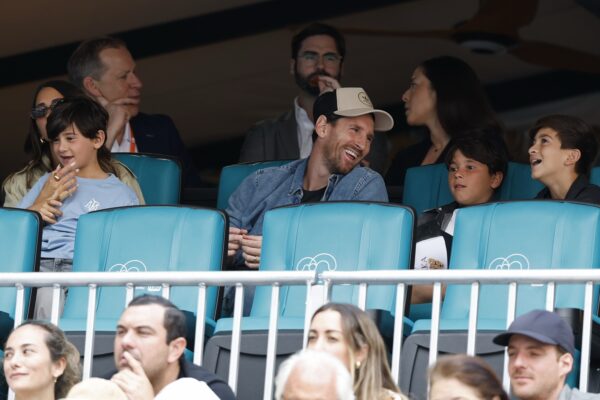 Mar 28, 2025; Miami, FL, USA; Inter Miami forward Lionel Messi (T-M) sits with his family in the stands during the match between Novak Djokovic (SRB) and Grigor Dmitrov (BUL)(both not pictured) in a men's singles semifinal on day eleven of the Miami Open at Hard Rock Stadium.