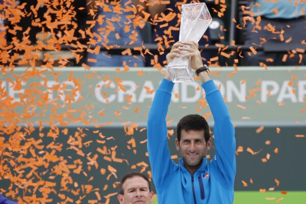 Apr 3, 2016; Key Biscayne, FL, USA; Novak Djokovic celebrates with the Butch Buchholz championship trophy after his match against Kei Nishikori (not pictured) in the men's singles final of the Miami Open at Crandon Park Tennis Center. Djokovic won 6-3, 6-3.
