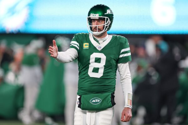 Jan 5, 2025; East Rutherford, New Jersey, USA; New York Jets quarterback Aaron Rodgers (8) gestures towards the Miami Dolphins bench during the second half at MetLife Stadium.