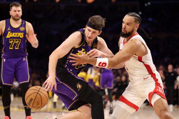 Los Angeles Lakers guard Austin Reaves (15) is defended by Houston Rockets forward Dillon Brooks (9) during the fourth quarter at Crypto.com Arena.