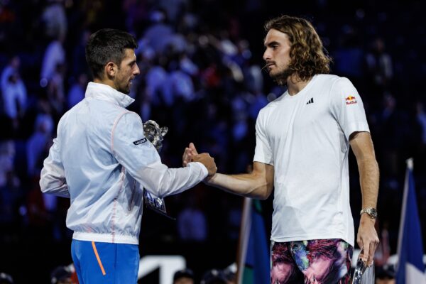 Jan 29, 2023; Melbourne, Victoria, Australia; Novak Djokovic of Serbia shakes hands with Stefanos Tsitsipas of Greece after the men's final on day fourteen of the 2023 Australian Open tennis tournament at Melbourne Park.