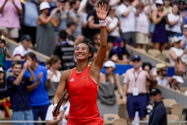 Aug 1, 2024; Paris, France; Qinwen Zheng of Team People's Republic of China celebrates winning against Iga Swiatek of Team Poland in the women’s singles semi-finals during the Paris 2024 Olympic Summer Games at Stade Roland Garros.