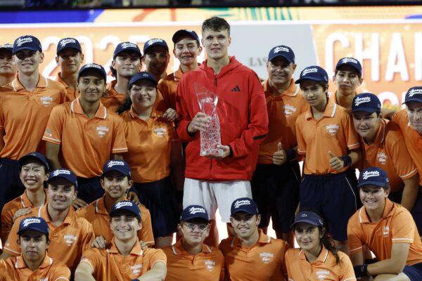 Mar 30, 2025; Miami, FL, USA; Jakub Mensik (CZE) celebrates with ball persons while holding the Butch Buchholz championship trophy after his match against Novak Djokovic (SRB)(not pictured) in the men's singles championship of the Miami Open at Hard Rock Stadium.