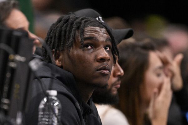 Feb 12, 2025; Dallas, Texas, USA; Miami Hurricanes Quarterback Cam Ward watches the game between the Dallas Mavericks and the Golden State Warriors during the second half at the American Airlines Center.