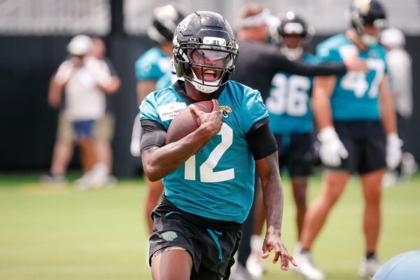 Jacksonville Jaguars wide receiver Travis Hunter (12) runs after completing a passing drill during rookie minicamp at Miller Electric Center.