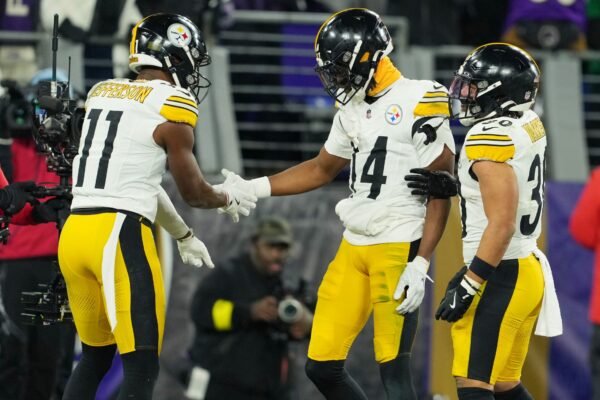 Pittsburgh Steelers wide receiver George Pickens (14) celebrates with wide receiver Van Jefferson (11) and running back Jaylen Warren (30) after scoring a touchdown against the Baltimore Ravens in the third quarter in an AFC wild card game at M&T Bank Stadium.