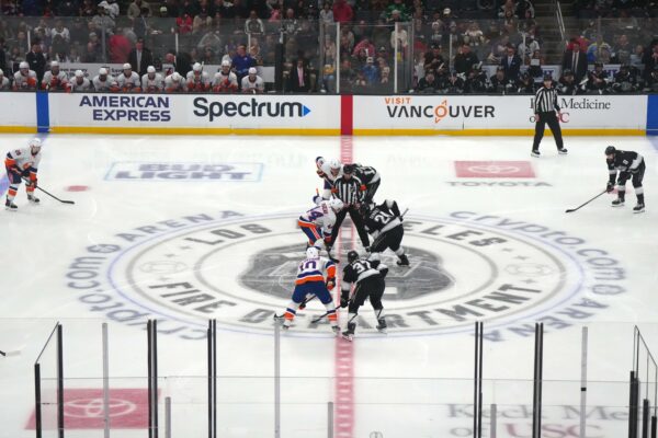 A general overall view as NHL referee Eric Furlatt (27), drops the puck on the opening faceoff between New York Islanders center Jean-Gabriel Pageau (44) and LA Kings center Phillip Danault (24) on the Los Angeles Fire Dept. logo at center ice at the Crypto.com Arena.