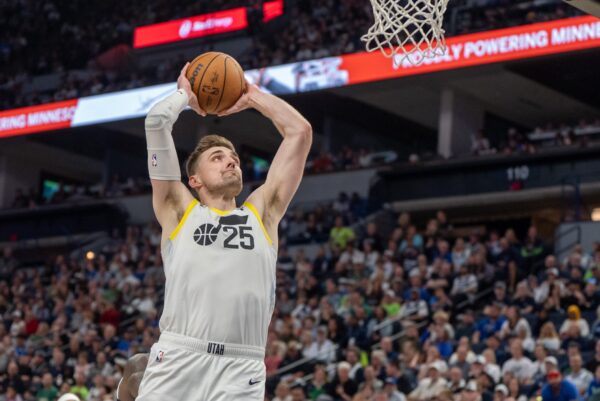 Utah Jazz center Micah Potter (25) finishes with a dunk after receiving a pass from guard Svi Mykhailiuk (19) in the fourth quarter against the Minnesota Timberwolves at Target Center.