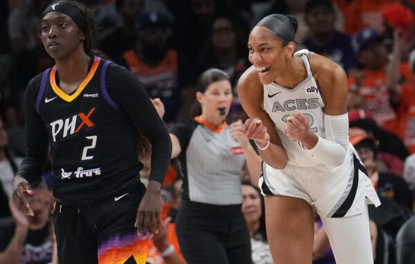 Las Vegas Aces center A'ja Wilson (22) celebrates a made shot as Phoenix Mercury guard Kahleah Copper (2) looks on during Game 3 of the WNBA Finals at Mortgage Matchup Center in Phoenix on Oct. 8, 2025.