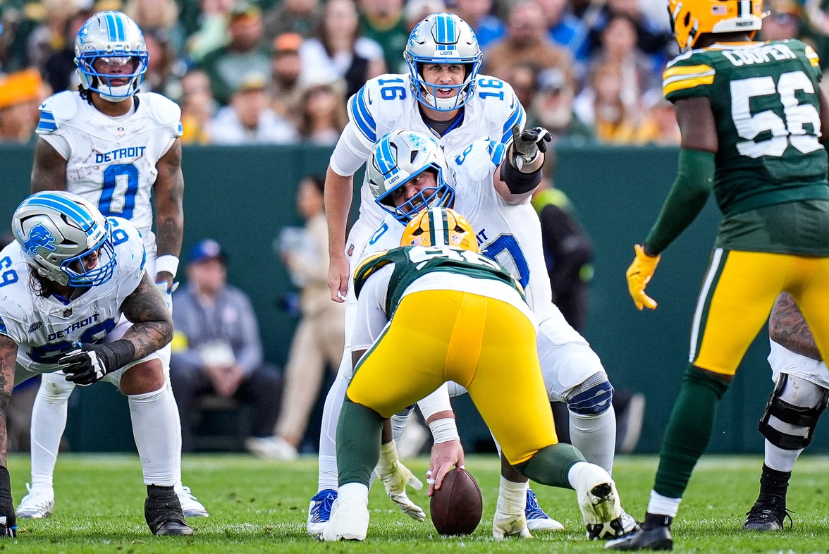 Detroit Lions quarterback Jared Goff (16) talks to guard Graham Glasgow (60) before a snap against Green Bay Packers during the second half at Lambeau Field in Green Bay, Wis.