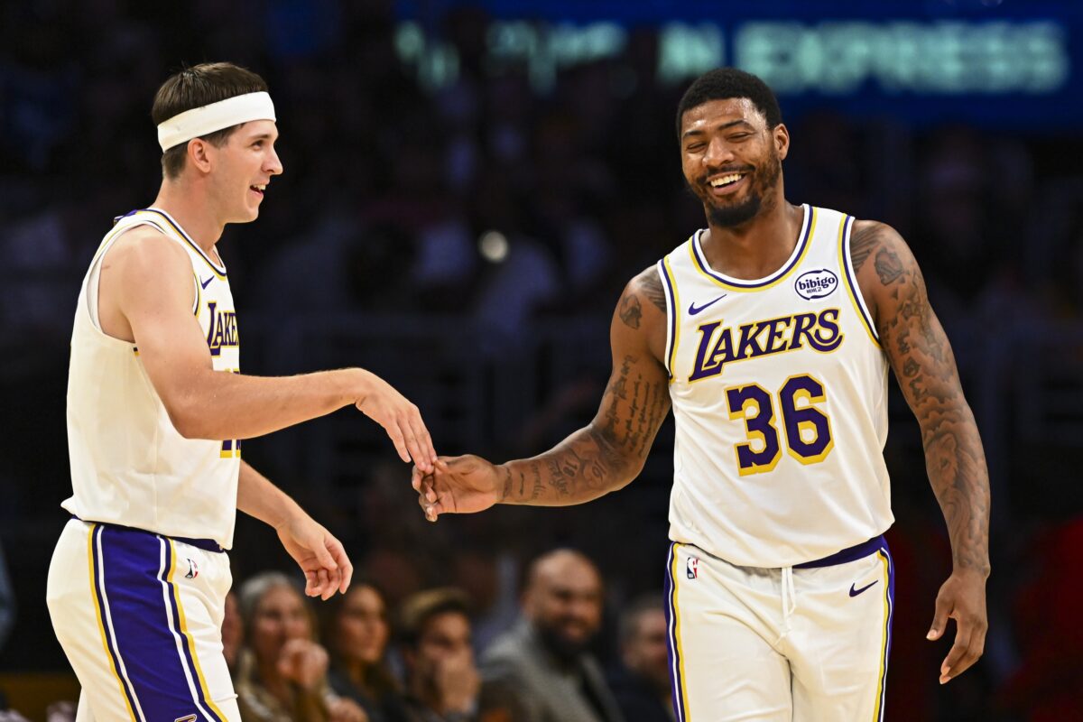 Los Angeles Lakers guard Austin Reaves (15) reacts with guard Marcus Smart (36) after scoring against the Miami Heat during the first half at Crypto.com Arena.