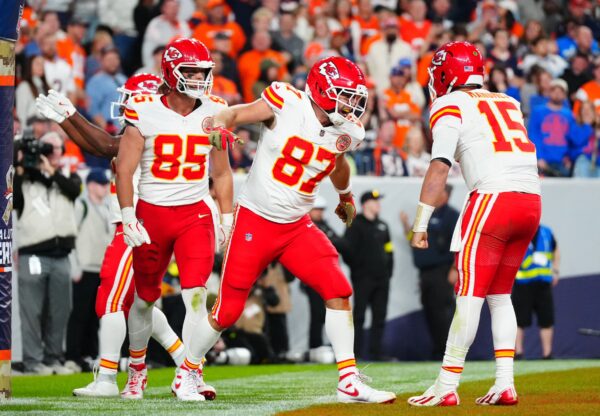Kansas City Chiefs tight end Travis Kelce (87) celebrates his touchdown with quarterback Patrick Mahomes (15) and tight end Robert Tonyan (85) in the fourth quarter at Empower Field at Mile High.