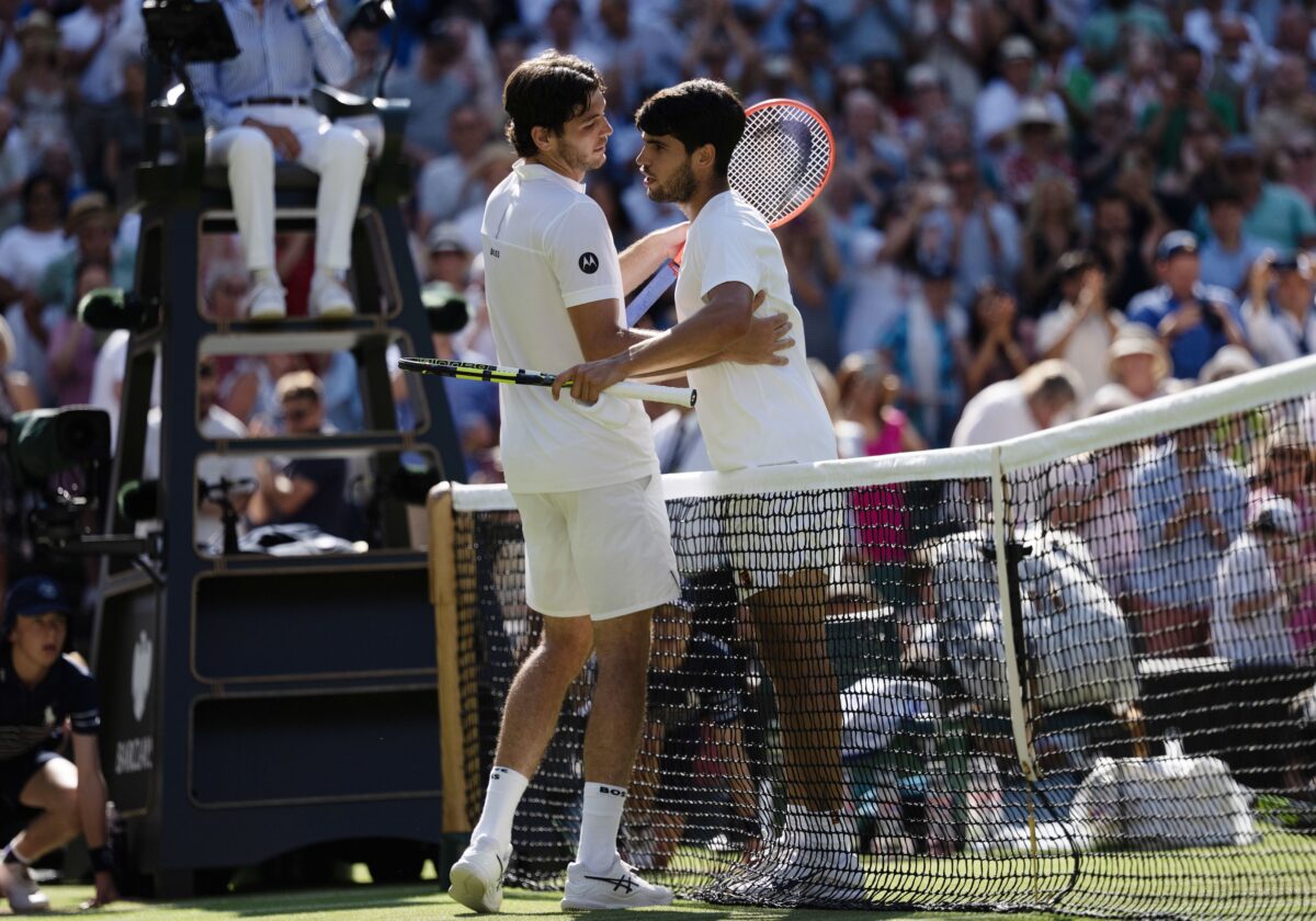 Jul 11, 2025; Wimbledon, United Kingdom; Taylor Fritz of the United States at the net with Carlos Alcaraz of Spain after their match on day 12 at All England Lawn Tennis and Croquet Club.