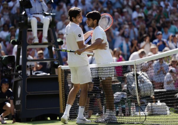 Jul 11, 2025; Wimbledon, United Kingdom; Taylor Fritz of the United States at the net with Carlos Alcaraz of Spain after their match on day 12 at All England Lawn Tennis and Croquet Club.