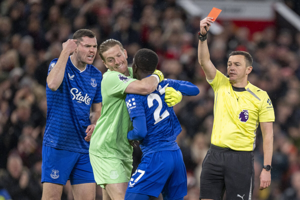 Idrissa Gueye of Everton restrained by Jordan Pickford of Everton whilst being shown red card by referee Tony Harrington for striking his own team-mate Michael Keane of Everton during the Premier League match between Manchester United, ManU and Everton at Old Trafford on November 24, 2025 in Manchester, England.