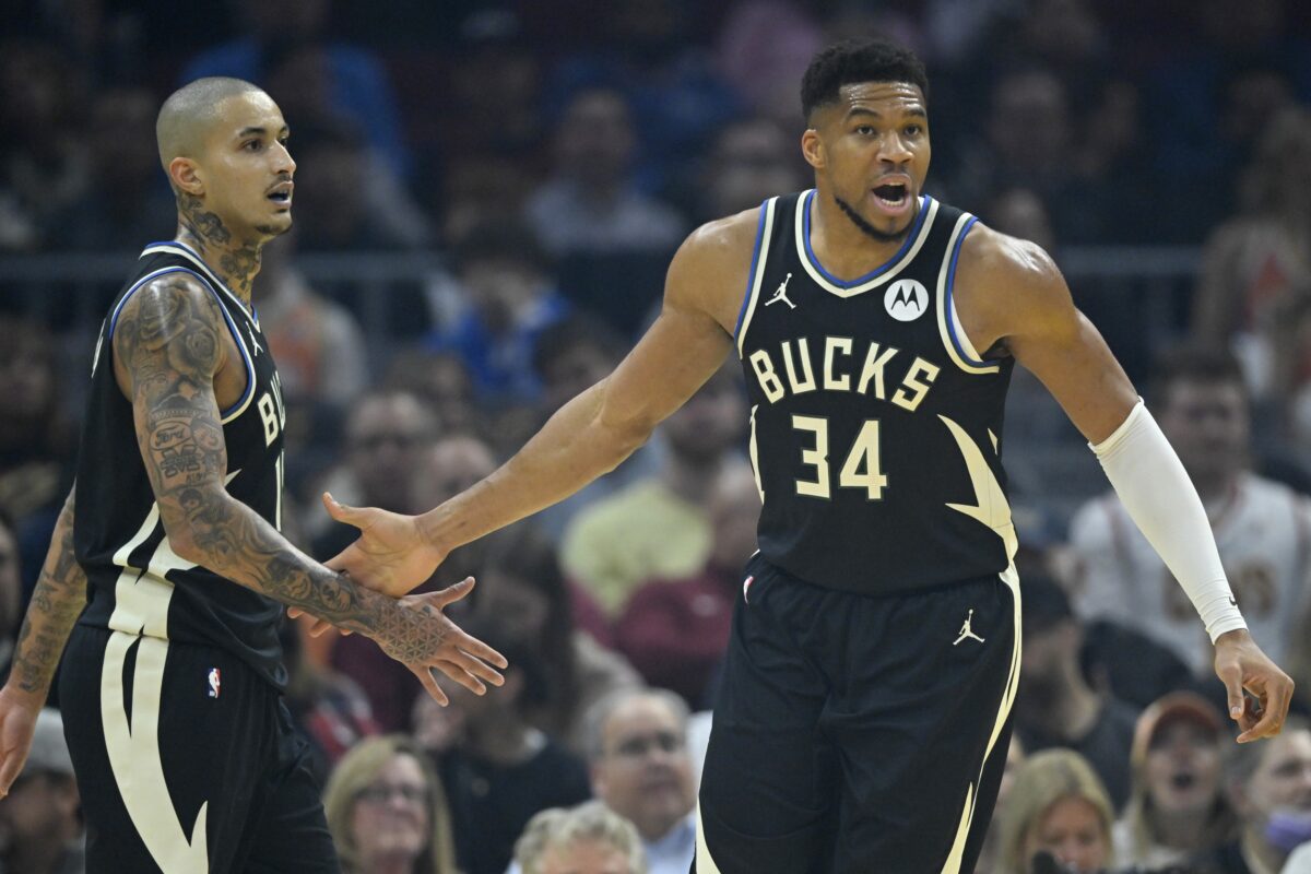 Milwaukee Bucks forward Kyle Kuzma (18) and forward Giannis Antetokounmpo (34) celebrate in the first quarter against the Cleveland Cavaliers at Rocket Arena.