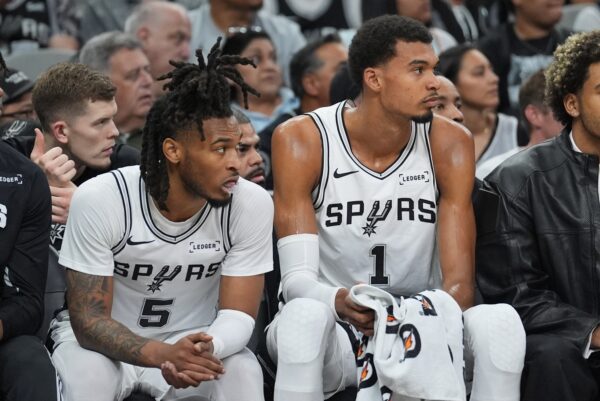 San Antonio Spurs guard Stephon Castle (5) and San Antonio Spurs forward Victor Wembanyama (1) look on in the first half against the Brooklyn Nets at Frost Bank Center.