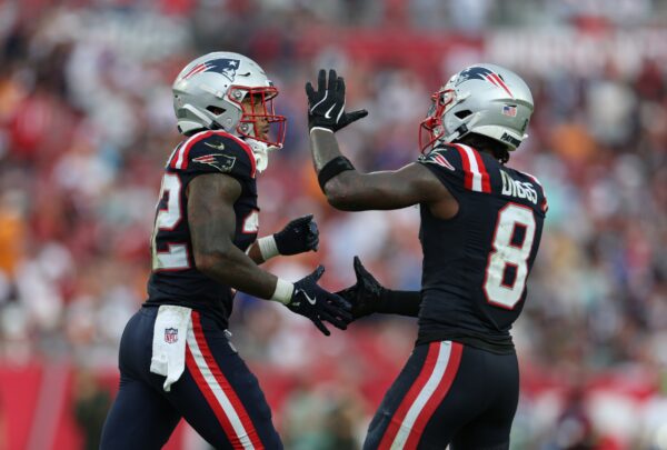 New England Patriots running back Treveyon Henderson (32) and wide receiver Stefon Diggs (8) celebrate a touchdown during the third quarter against the Tampa Bay Buccaneers at Raymond James Stadium.