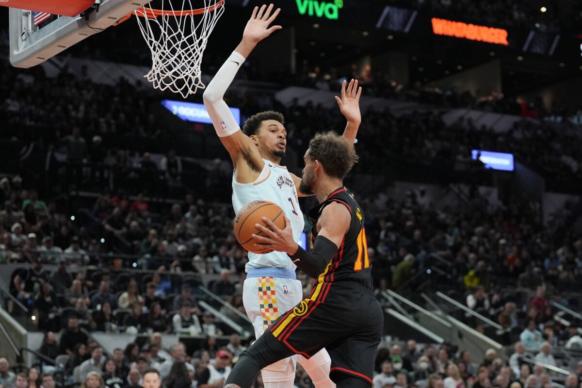 Atlanta Hawks guard Trae Young (11) goes up against San Antonio Spurs center Victor Wembanyama (1) in the second half at Frost Bank Center.