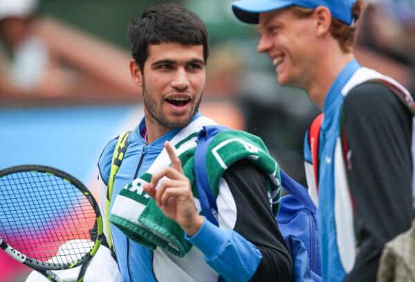 Carlos Alcaraz and Jannik Sinner chat while leaving the court for a rain delay at the BNP Paribas Open in Indian Wells, Calif., March 16, 2024.