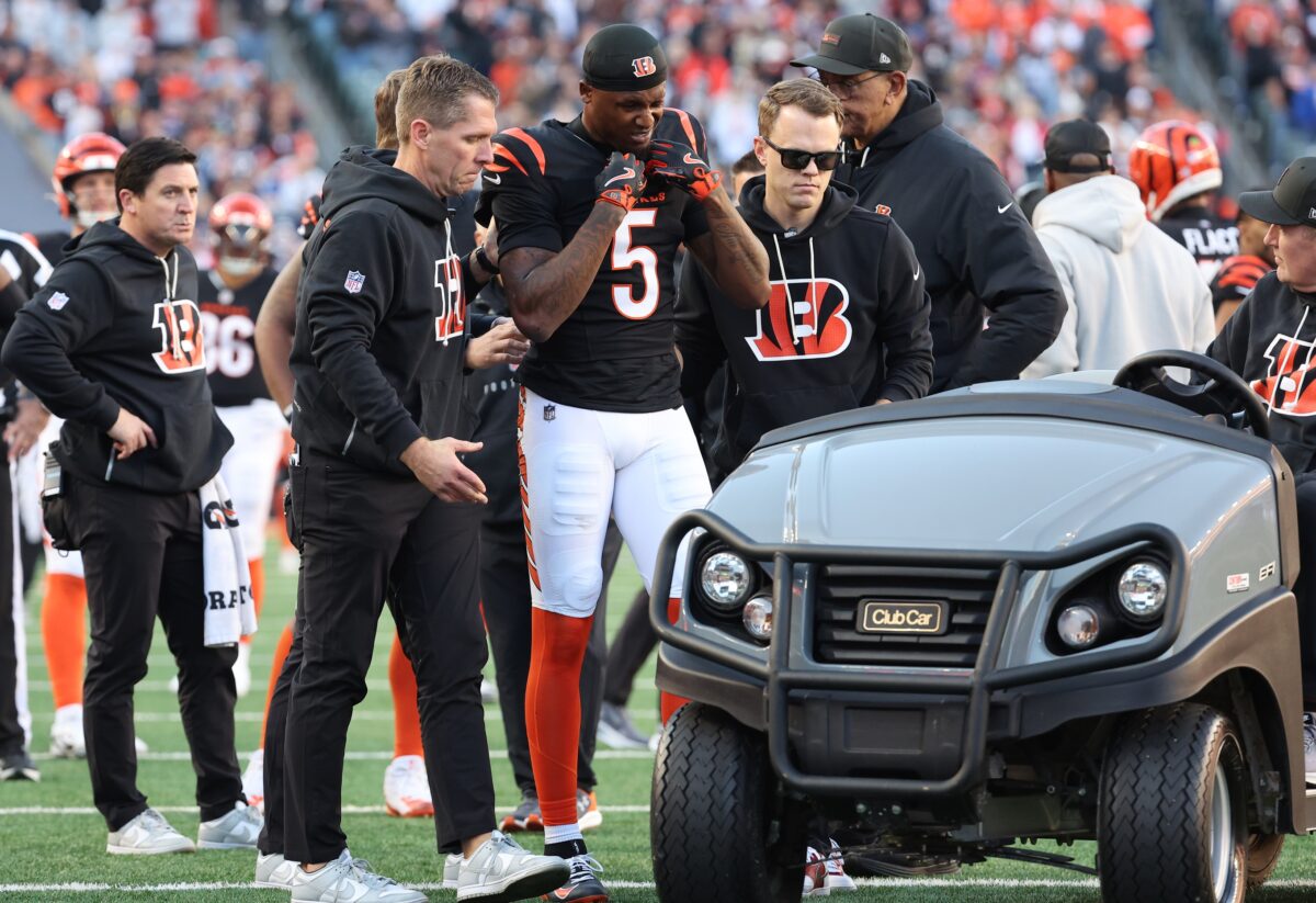 Cincinnati Bengals wide receiver Tee Higgins (5) is helped to a cart after an injury during the second half against the New England Patriots at Paycor Stadium.