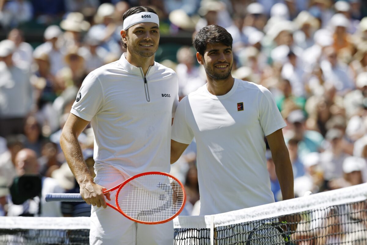 Jul 11, 2025; Wimbledon, United Kingdom; Taylor Fritz (USA)(L) and Carlos Alcaraz (ESP)(R) pose for a picture at the net prior to warm up before their gentlemen's singles semi-final on day 11 of The Championships Wimbledon 2025 at All England Lawn Tennis and Croquet Club.