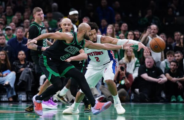 Detroit Pistons guard Cade Cunningham (2) and Boston Celtics guard Derrick White (9) work for the ball in the last seconds of the fourth quarter at TD Garden.