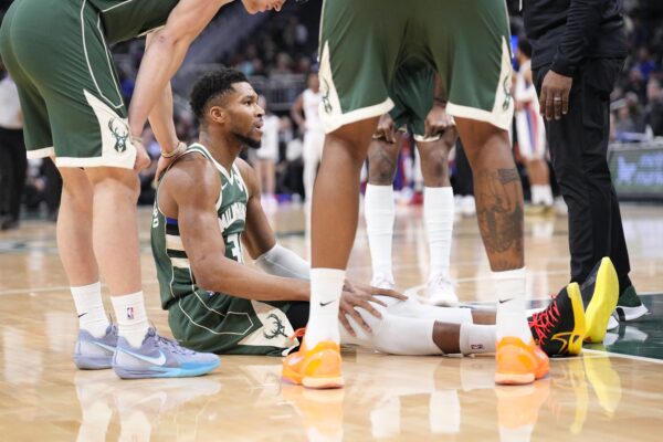 Milwaukee Bucks forward Giannis Antetokounmpo (34) goes down with an injury against the Detroit Pistons in the first half at Fiserv Forum.