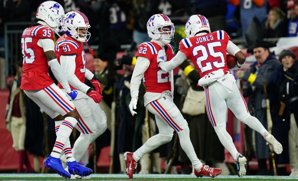 New England Patriots cornerback Charles Woods (22) and New England Patriots cornerback Marcus Jones (25) celebrate after returning a punt for a touchdown during the first quarter against the New York Giants at Gillette Stadium.