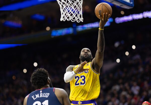 Los Angeles Lakers forward LeBron James (23) scores past Philadelphia 76ers center Joel Embiid (21) during the second quarter at Wells Fargo Center.