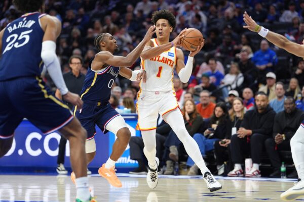 Atlanta Hawks forward Jalen Johnson (1) drives against Philadelphia 76ers guard Tyrese Maxey (0) in the second quarter at Xfinity Mobile Arena.