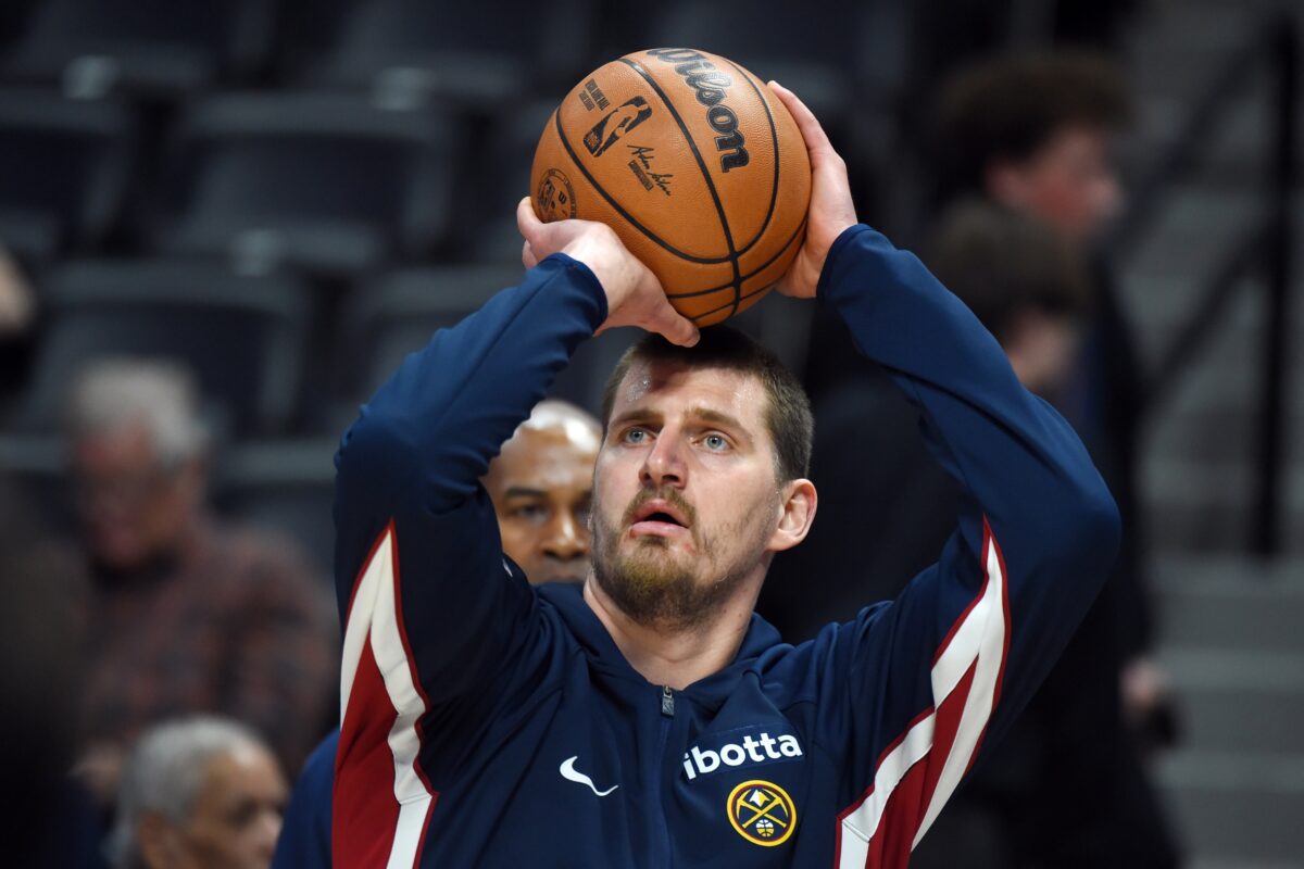 Denver Nuggets center Nikola Jokic (15) warms up before the game against the Boston Celtics at Ball Arena.
