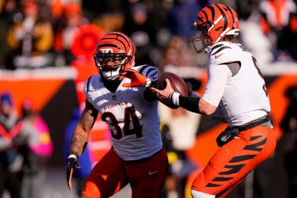 Cincinnati Bengals quarterback Joe Burrow (9) fakes a hand off to running back Samaje Perine (34) in the second quarter of the NFL Week 15 game between the Cincinnati Bengals and the Baltimore Ravens at Paycor Stadium in Cincinnati on Sunday, Dec. 14, 2025.