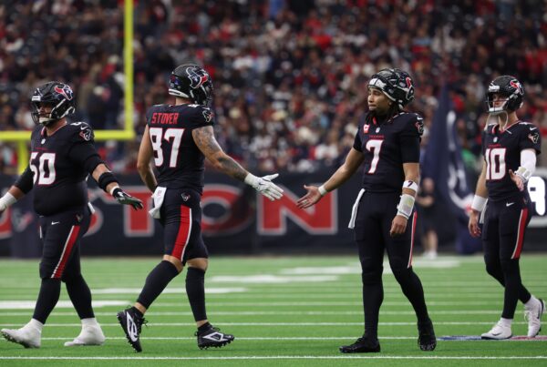 Houston Texans quarterback C.J. Stroud (7) high-fives tight end Cade Stover (87) during the second quarter against the Arizona Cardinals at NRG Stadium.