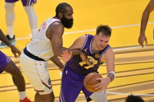 Harden cerca di difendere su Luka Doncic