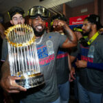 PHOENIX, AZ - NOVEMBER 01: Adolis García #53 of the Texas Rangers celebrates in the clubhouse with the commissioner's trophy after Game 5 of the 2023 World Series between the Texas Rangers and the Arizona Diamondbacks at Chase Field on Wednesday, November 1, 2023 in Phoenix, Arizona.