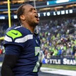 SEATTLE, WASHINGTON - JANUARY 08: Geno Smith #7 of the Seattle Seahawks celebrates after defeating the Los Angeles Rams in overtime at Lumen Field on January 08, 2023 in Seattle, Washington