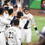 MIAMI, FLORIDA - MARCH 21: Munetaka Murakami #55 of Team Japan celebrates with teammates after hitting a solo home run in the bottom of the second inning during World Baseball Classic Championship between United States and Japan at loanDepot park on March 21, 2023 in Miami, Florida