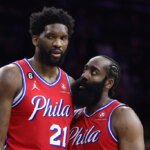 PHILADELPHIA, PENNSYLVANIA - DECEMBER 23: Joel Embiid #21 and James Harden #1 of the Philadelphia 76ers speak during the fourth quarter against the LA Clippers at Wells Fargo Center on December 23, 2022 in Philadelphia, Pennsylvania.