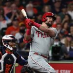 HOUSTON, TEXAS - APRIL 28: Kyle Schwarber #12 of the Philadelphia Phillies hits a home run in the first inning against the Houston Astros at Minute Maid Park on April 28, 2023 in Houston, Texas.
