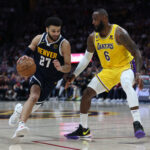 DENVER, COLORADO - MAY 18: Jamal Murray #27 of the Denver Nuggets drives against LeBron James #6 of the Los Angeles Lakers during the third quarter in game two of the Western Conference Finals at Ball Arena on May 18, 2023 in Denver, Colorado.