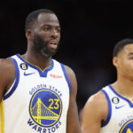 PHOENIX, ARIZONA - OCTOBER 25: (L-R) Draymond Green #23 and Jordan Poole #3 of the Golden State Warriors walk to the bench during the second half of the NBA game against the Phoenix Suns at Footprint Center on October 25, 2022 in Phoenix, Arizona. The Suns defeated the Warriors 134-105.