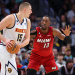 DENVER, CO - DECEMBER 30: Bam Adebayo #13 of the Miami Heat defends Nikola Jokic #15 of the Denver Nuggets during the first quarter at Ball Arena on December 30, 2022 in Denver, Colorado.