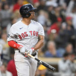 SAN DIEGO, CA - MAY 19: Rafael Devers #11 of the Boston Red Sox hits a three-run home run during the third inning of a baseball game against the San Diego Padres at Petco Park on May 19, 2023 in San Diego, California