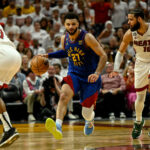 MIAMI, FL - JUNE 7: Jamal Murray (27) of the Denver Nuggets handles as Caleb Martin (16) of the Miami Heat defends in the fourth quarter of the Nuggets' 104-94 win during Game 3 of the NBA Finals at the Kaseya Center in Miami on Wednesday, June 7, 2023